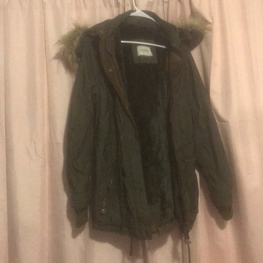 Puffy green jacket with fur around hood